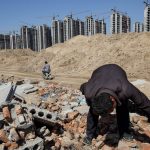 Li Rui, 60, scavenges his former village -- now bulldozed into a giant construction site -- for building materials in Liaocheng in the northeastern Chinese province of Shangdong.