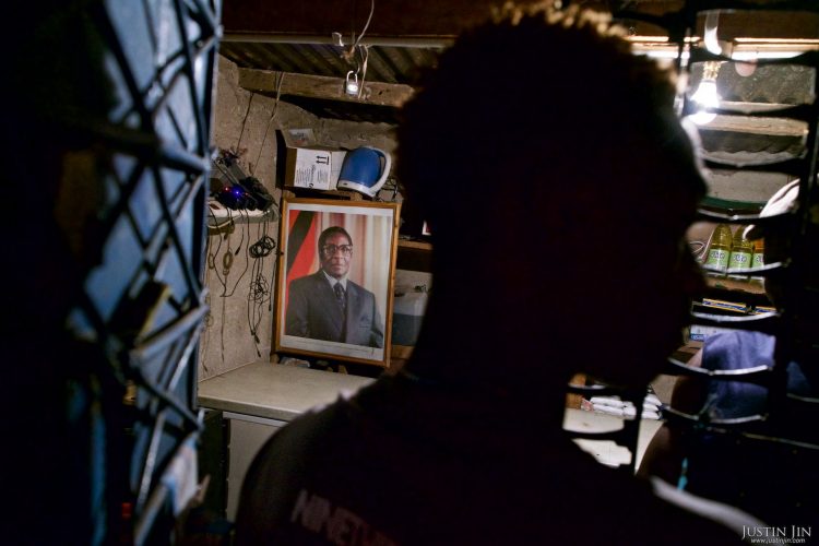 A portrait of Zimbabwean President Robert Mugabe hangs in a shop near Harare. Pictures shot by Justin Jin